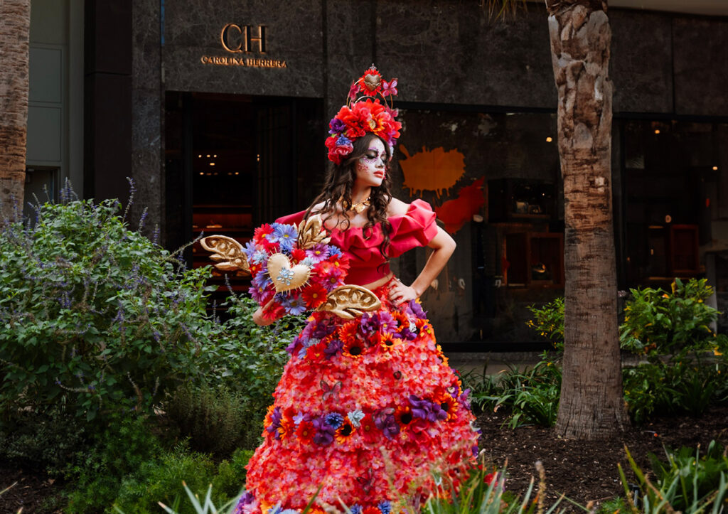 Catrinas in Motion presentation featuring cultural fashion icons walking through an open-air space
